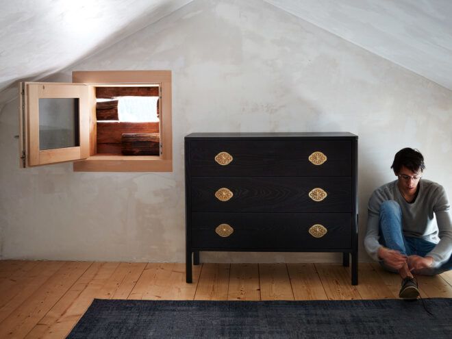A person on the right sitting next to eco-friendly furniture on the left.