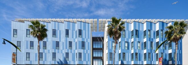 A large rectangle blue apartment complex