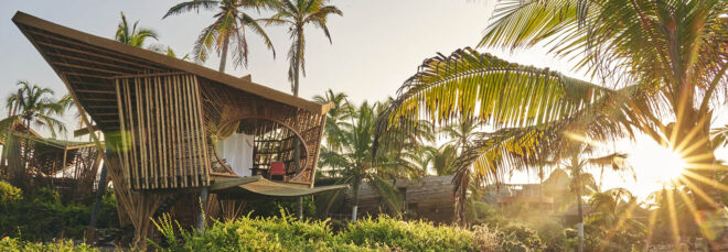 Two bamboo structures on the beach.