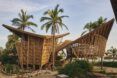 Two bamboo structures on the beach.