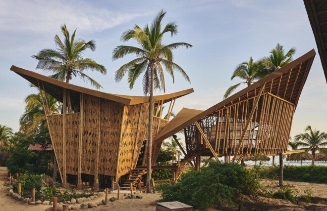 Two bamboo structures on the beach.