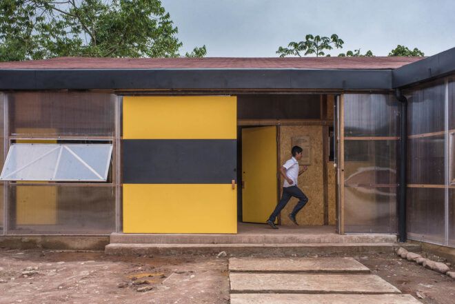 A student running through a bioclimatic school/dorm building.