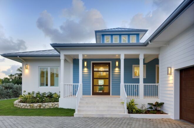 A white house with blue walls painted and a white front porch