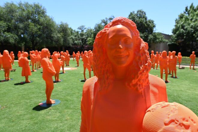 Orange 3D printed sculptures of woman trailblazers