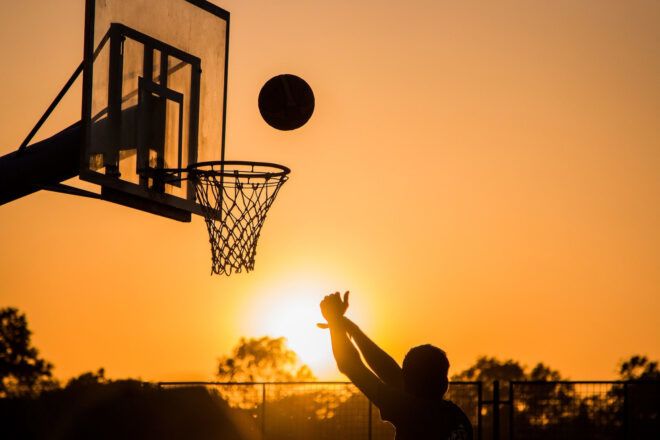 A person shooting a basketball.