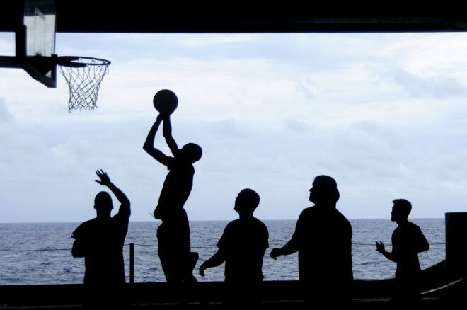 A person shooting a basketball.