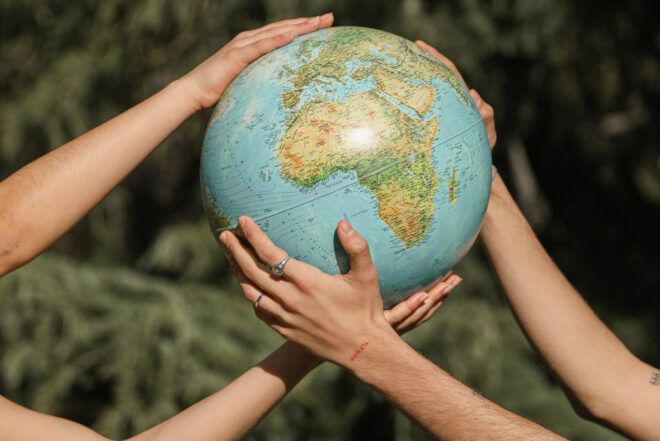 Environmental news illustrated by two people holding a globe.