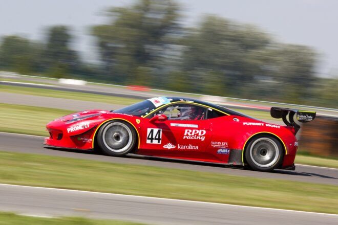 A red sports vehicle racing on a track