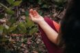 A person meditating in nature.