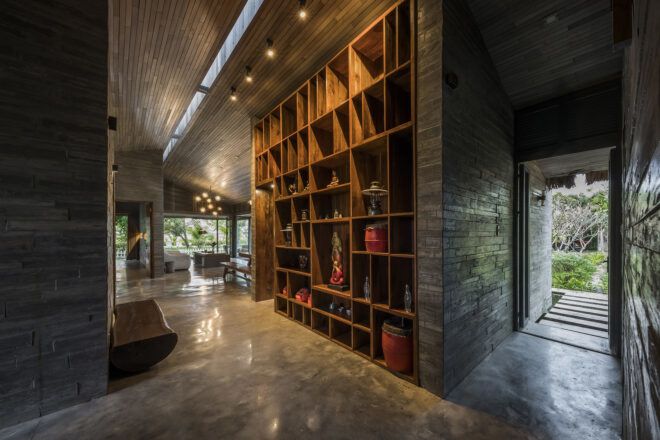 A wooden bookshelf leading down a hallway