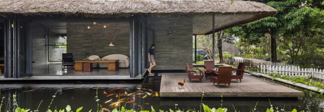 The side of the house features koi fish swimming in a pond that runs around the entire house