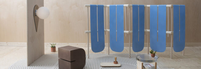 A display of various furniture from Grain Design including a blue hanging object, a brown stool and a lighting system