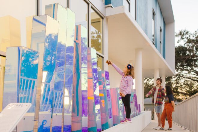 Various heights of rectangle holographic blocks with people looking at it