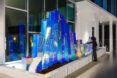 Inside a building a holographic light up artwork looks like rectangle blocks in varying heights