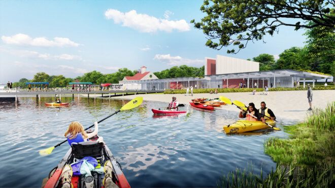 A water bank area where people are kayaking in red and yellow boats and paddles