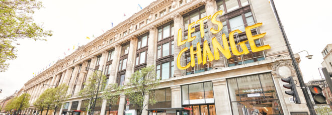 A building that reads in yellow font "Let's Change"