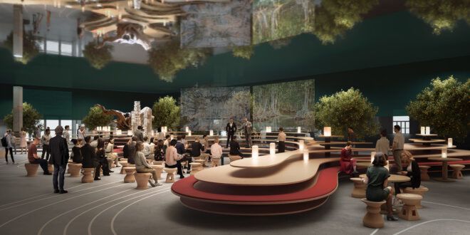 An auditorium Design with Nature is filled with people sitting down facing a person speaking at the front of the room