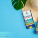 A reef-safe sunscreen against a blue background.