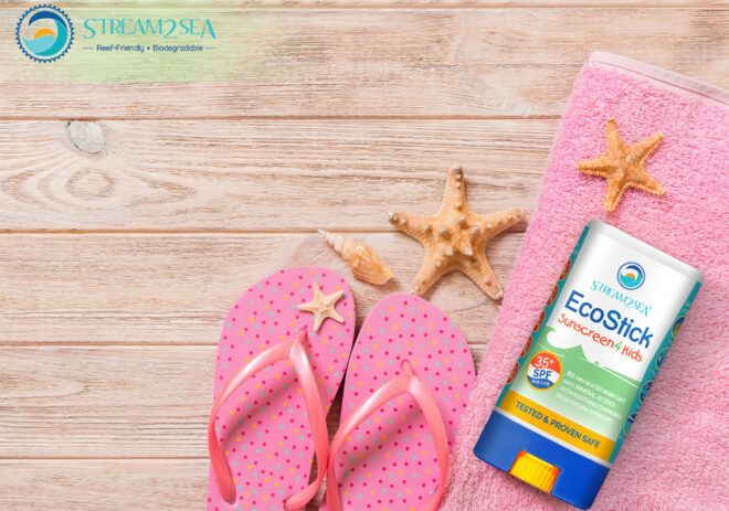 A graphic of a reef-safe sunscreen on a pink towel next to pink flipflops.