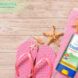 A graphic of a reef-safe sunscreen on a pink towel next to pink flipflops.