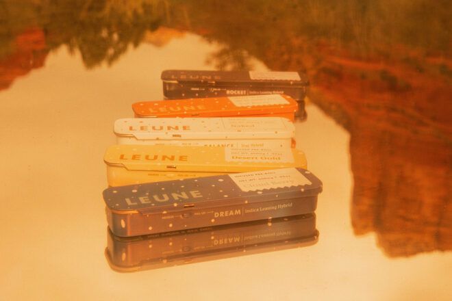 Four different color packaging that reads Leune on them from dark blue, yellow, white, orange and a black container