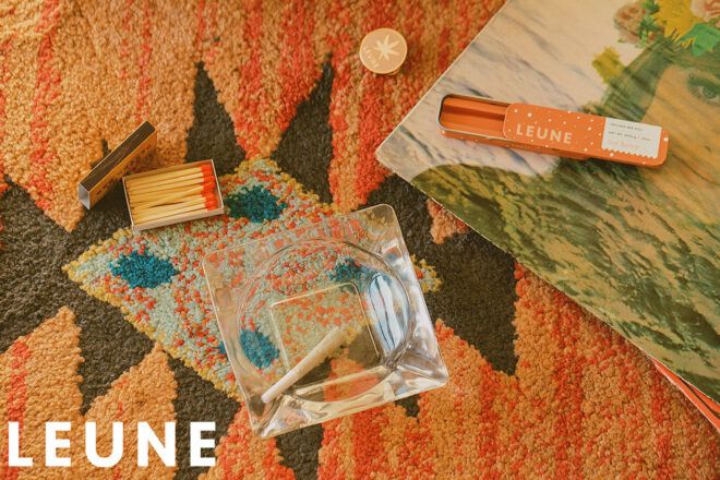 A scattered spread of a container, some paper and a candle