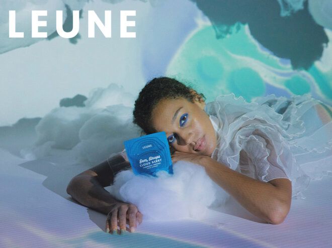 A person lays down with a blue container with the words LEUNE in the upper left corner