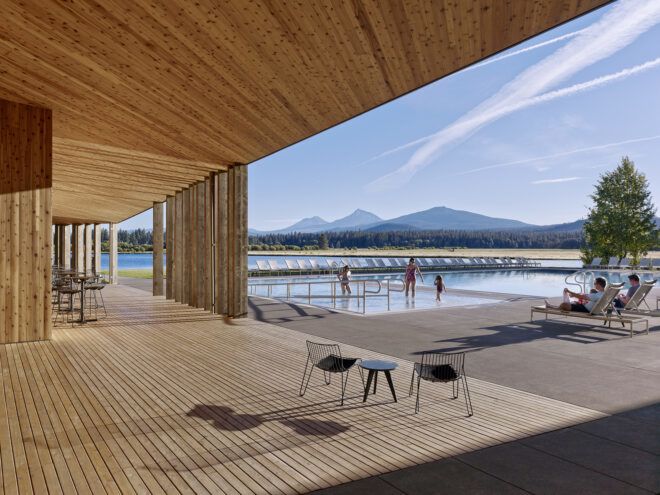 A wooden overhang extends out to the exterior landscape