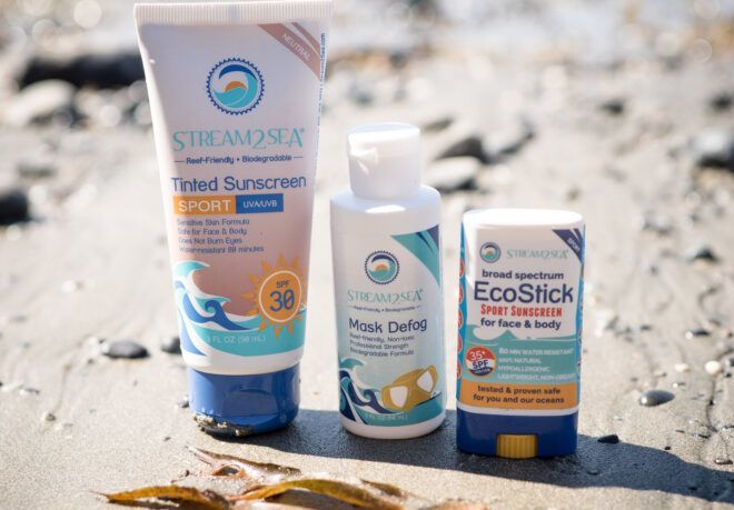 Three reef-safe sunscreens on the beach.