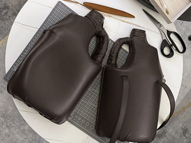 Two brown gallon jugs lay on a work tbale