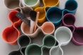 Multicolor pen holders such as orange, white, pink, dark blue, dark green and purple