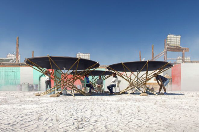 People sitting under three portable solar water distillers
