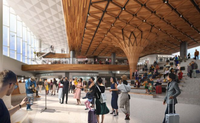 An auditorium area inside an airport filled with people walking around