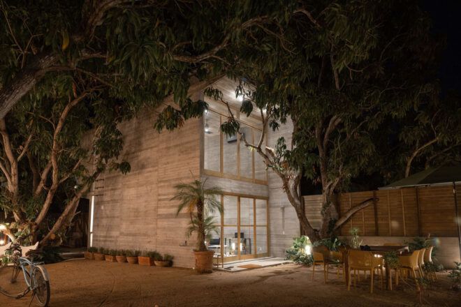 A two-story house that it lit from inside during a dark night