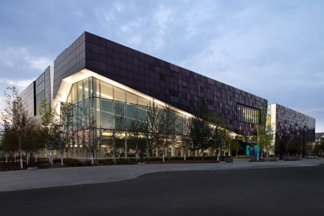 A black building that is partly made out of glass and Dri-Design metal panels