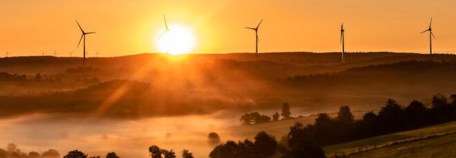 Wind mills on the horizon, illustrating the new IPCC report focus on climate change mitigation efforts.