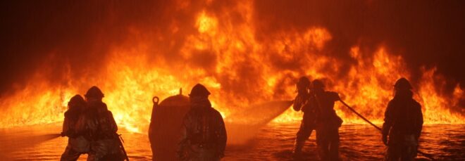 Firefighters fighting a raging fire