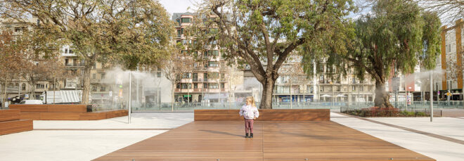 A little child standing on a brick ground area