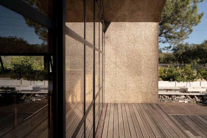 A close-up of the glass panel and wooden flooring of the outside