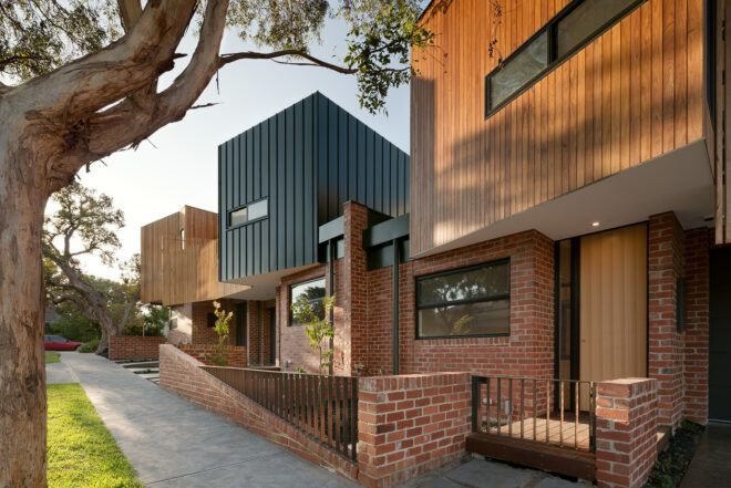 A row of townhouses against a sidewalk