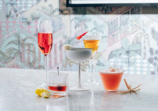An assortment of cocktails in different glasswares including a flute and a cup