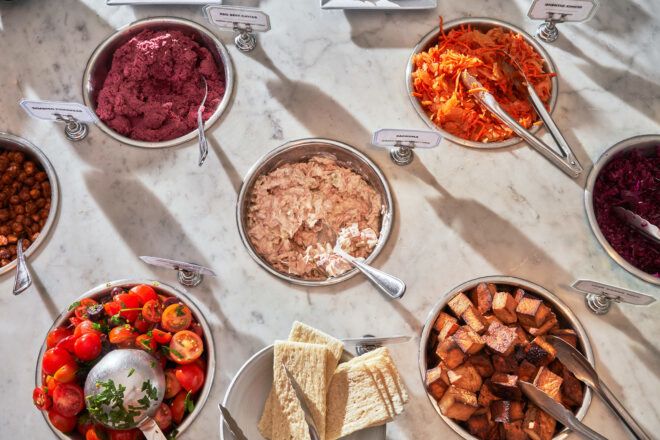 Different bowls of dips and utensils for picking them up