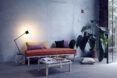 A sofa, coffee table in front of it and a standing lamp beside the sofa