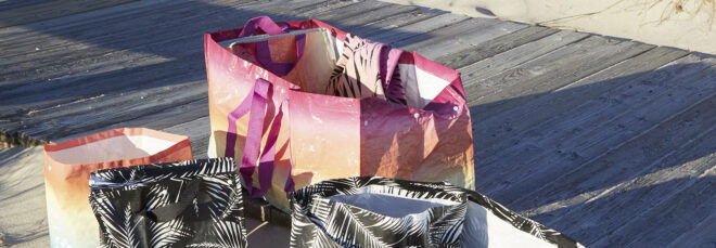 Tote bags laying on sand