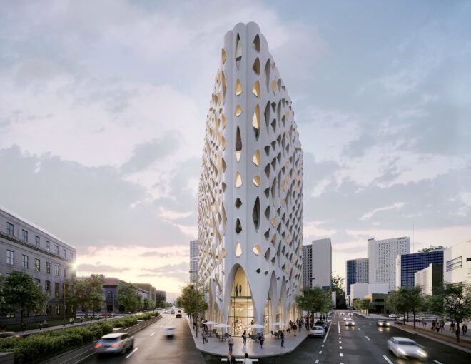 A triangular white hotel building with multiple windows