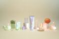Purple, orange and green beauty products in bottles and tubes