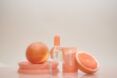 A clear bottle with grapefruits set against it