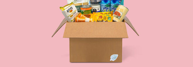 A box full of food against a pink background