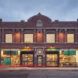 A market storefront is a brick building facing a street