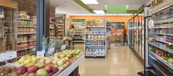 An overview look at the Fresh Market with freezer on against the right walls and product and snacks in the middle and left